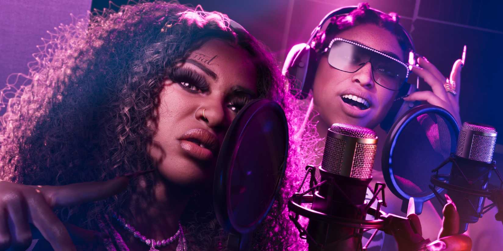 GTA6 screenshot of two caracters performing into mics with pink lighting