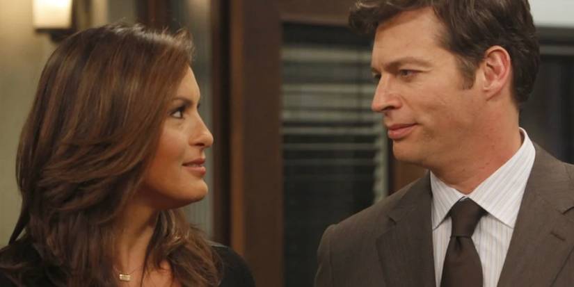 Mariska Hargitay and Harry Connick Jr smiling at one another in Law and Order: SVU
