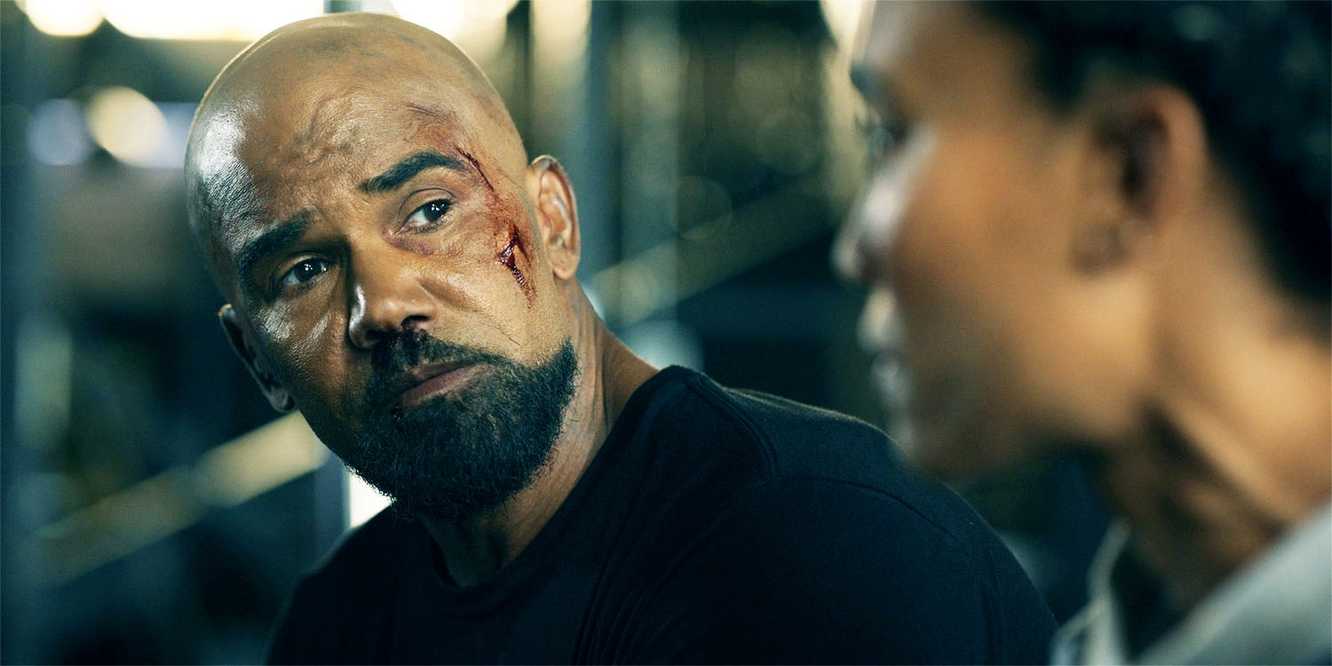 Hondo looking at at a teammate mid-conversation, in SWAT season 8