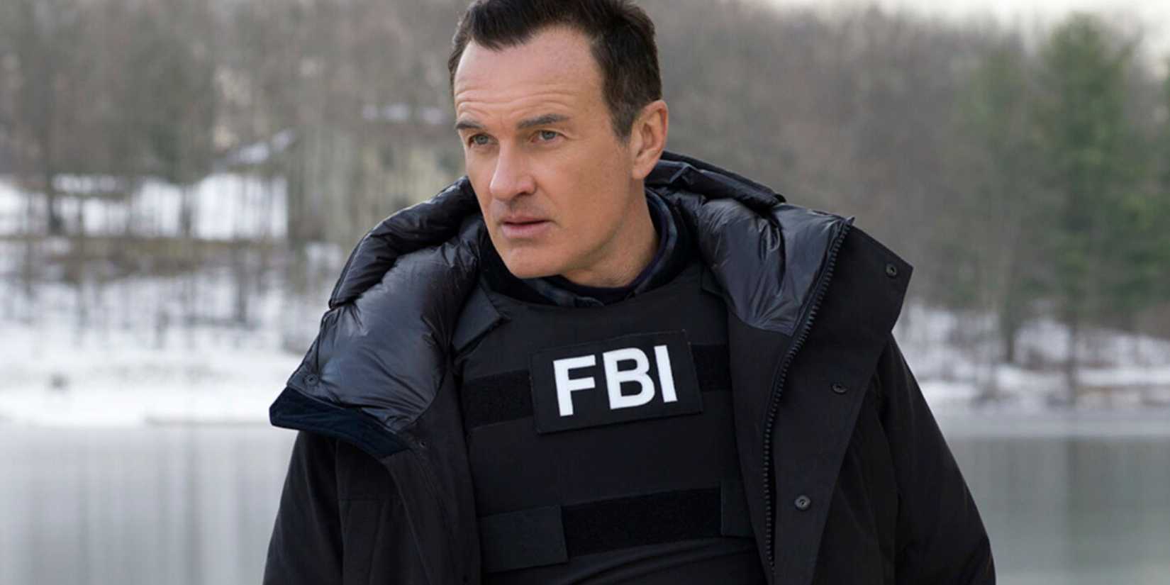 Jess La Croix in FBI Most Wanted standing by a lake with his FBI jacket