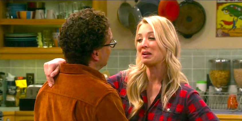Kaley Cuoco's Penny smiles while embracing Johnny Galecki's Leonard in The Big Bang Theory
