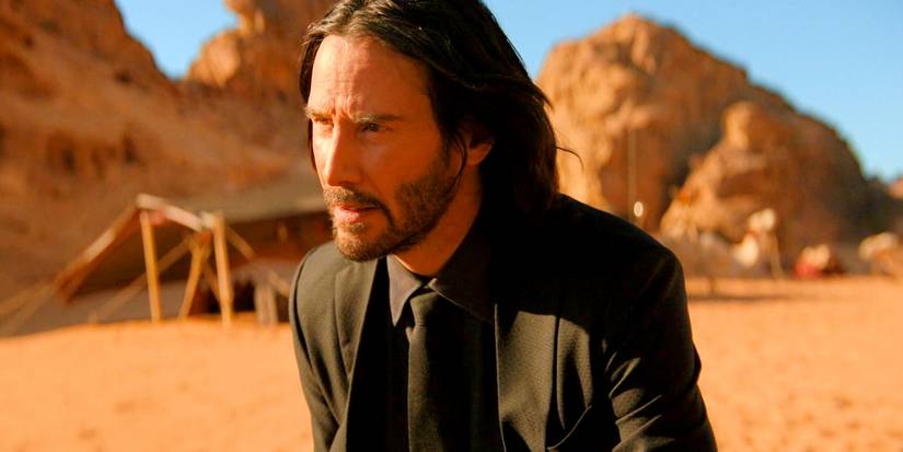 Keanu Reeves as John Wick looking stern in the desert in John Wick Chapter 4