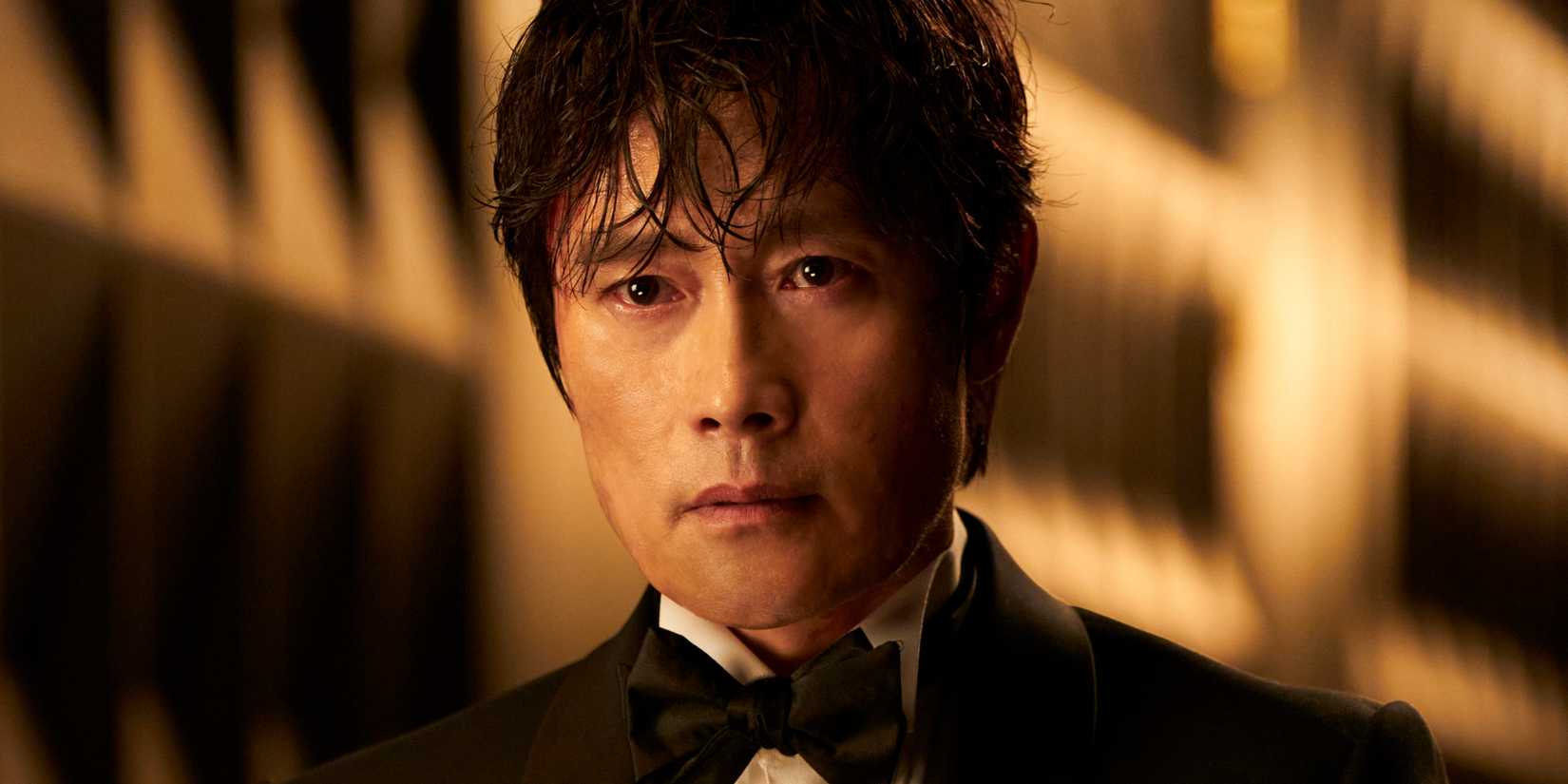 Lee Byung-hun as In-ho wearing a suit while his eyes water intensely in Squid Game season 3