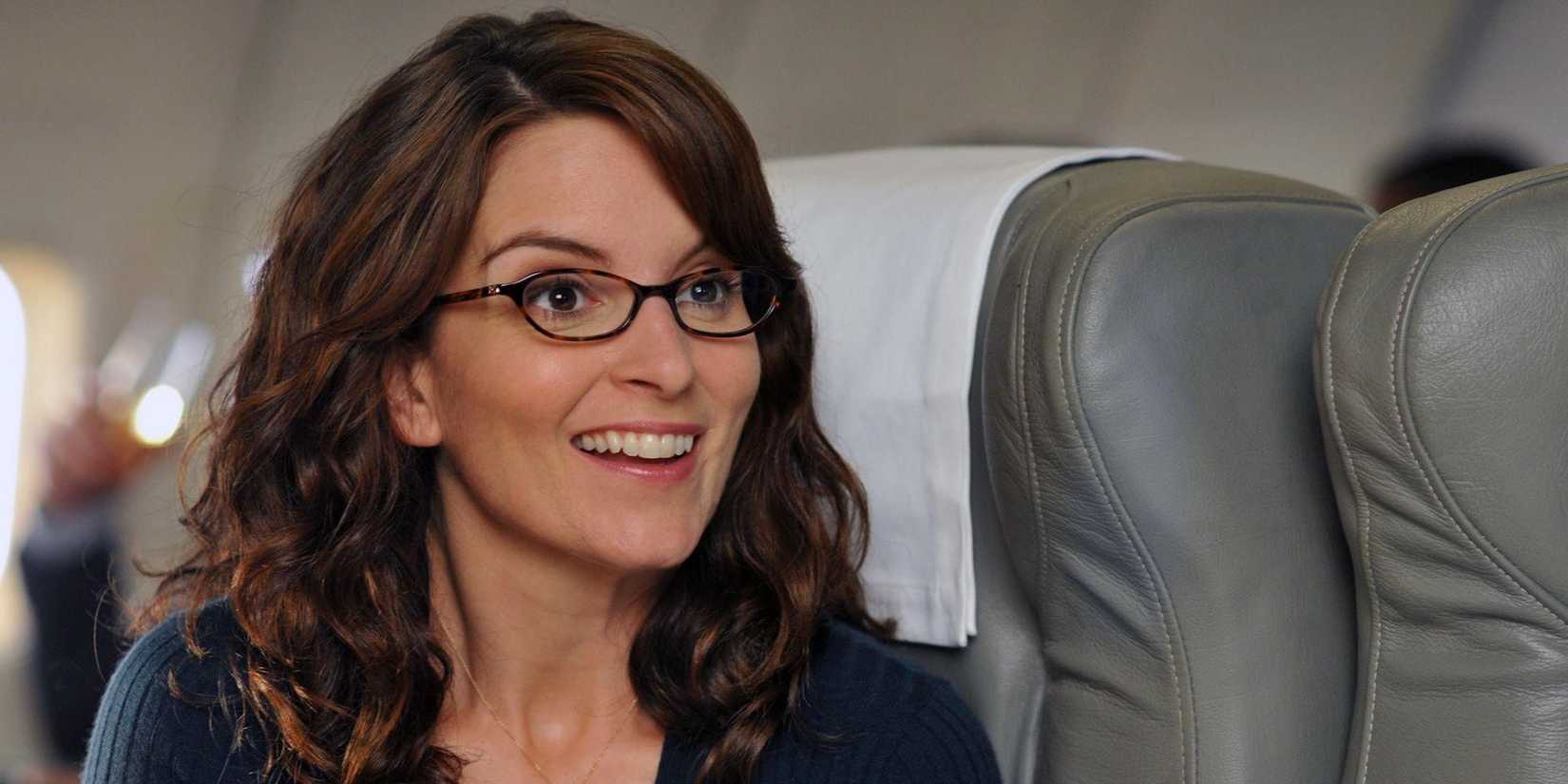 liz lemon tina fey smiling on a plane in 30 rock