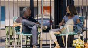 Ballard and Bosch sit outside under a sun umbrella in Ballard