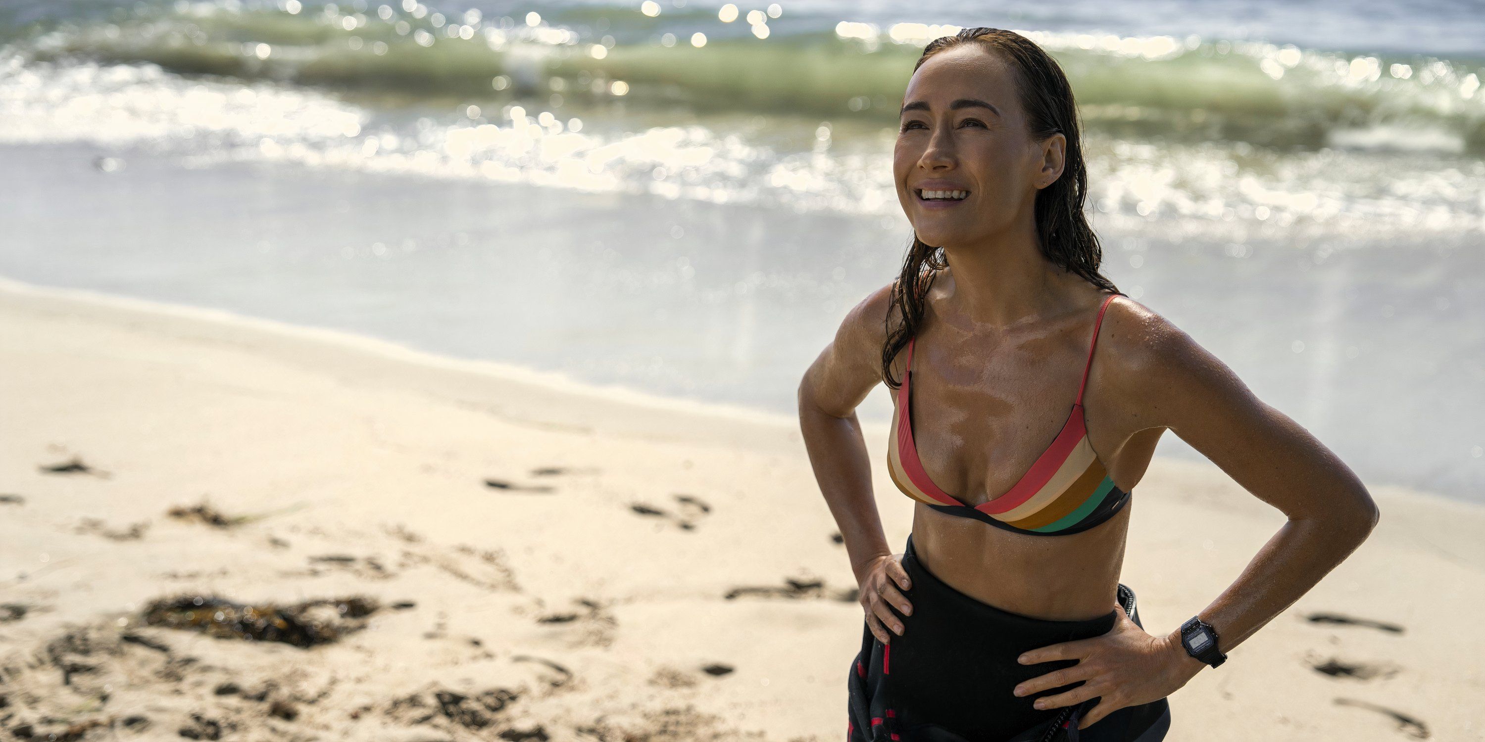 Renee Ballard stands on the beach smiling in Ballard season 1