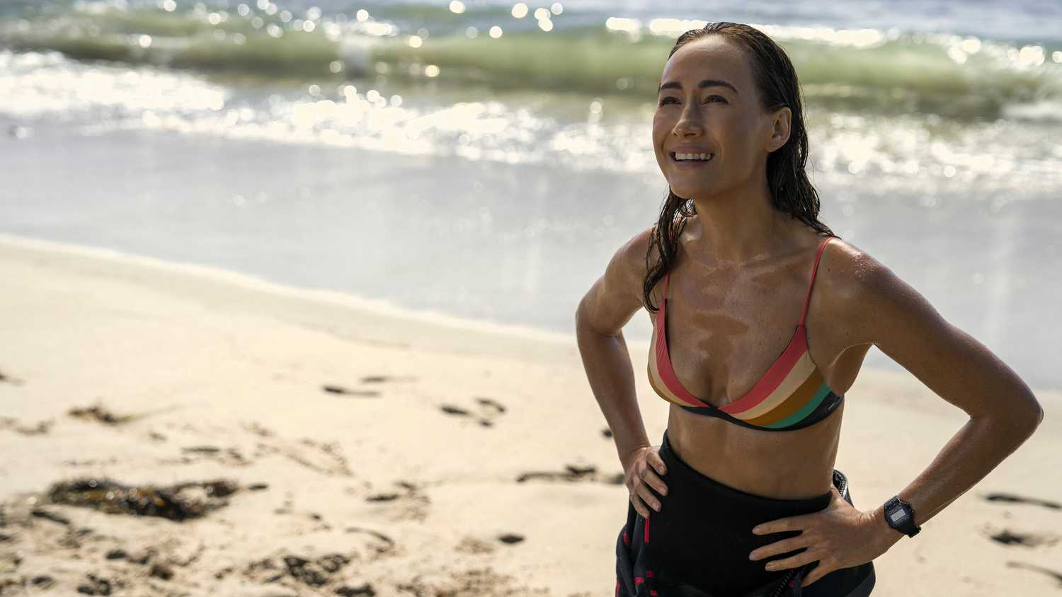 Renee Ballard stands on the beach smiling in Ballard season 1