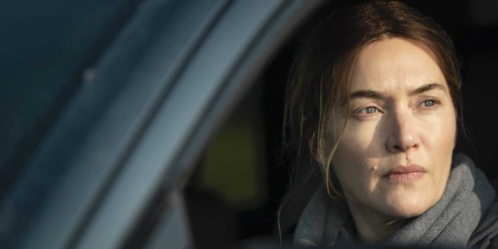Mare (Kate Winslet) looking out her car window in Mare of Easttown.-1