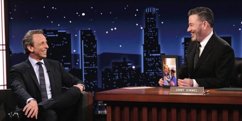 Seth Meyers sitting as a guest on Jimmy Kimmel Live!