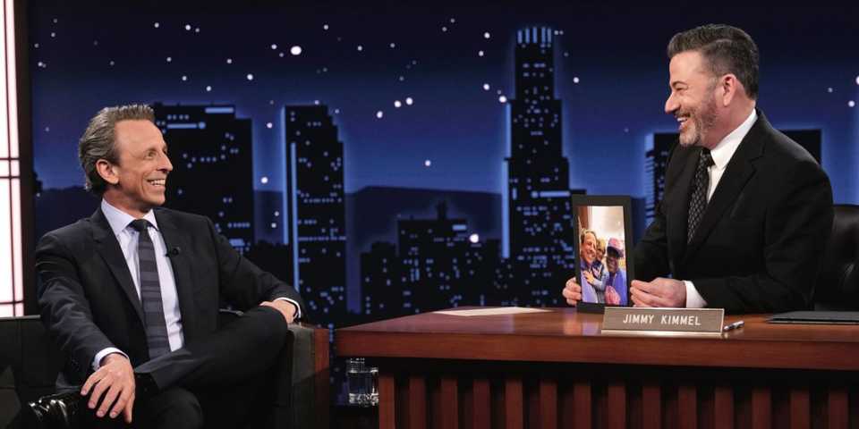 Seth Meyers sitting as a guest on Jimmy Kimmel Live!