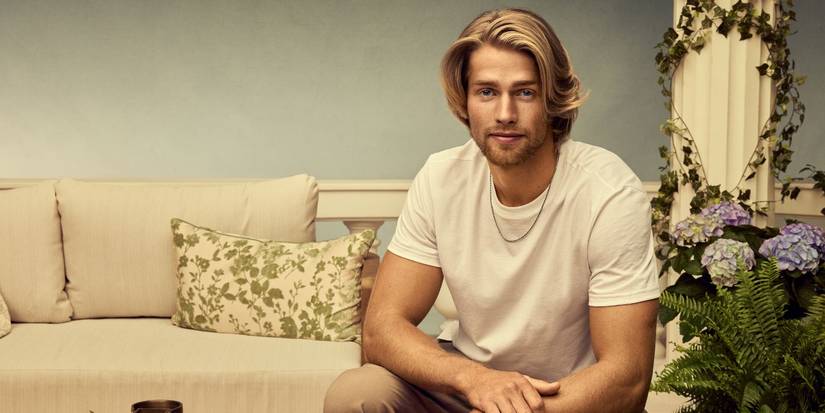 Welcome to Plathville's Micah Plath posing in a white tee and gold chain