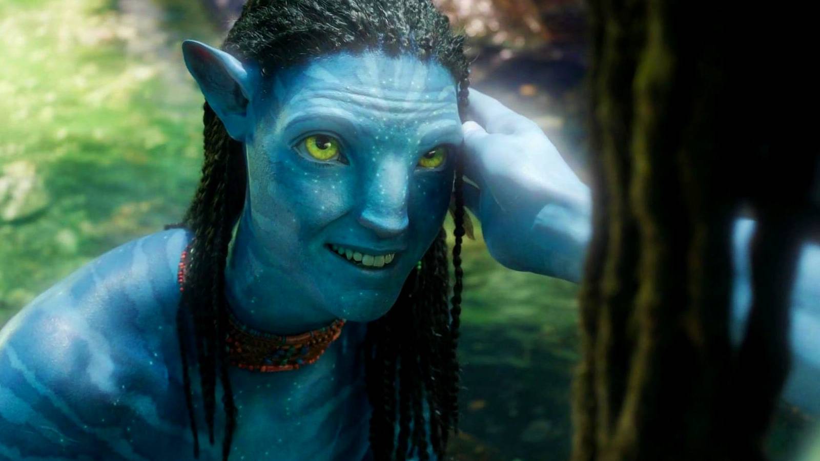 Neteyam smiling up at someone who strokes his face in Avatar the Way of Water