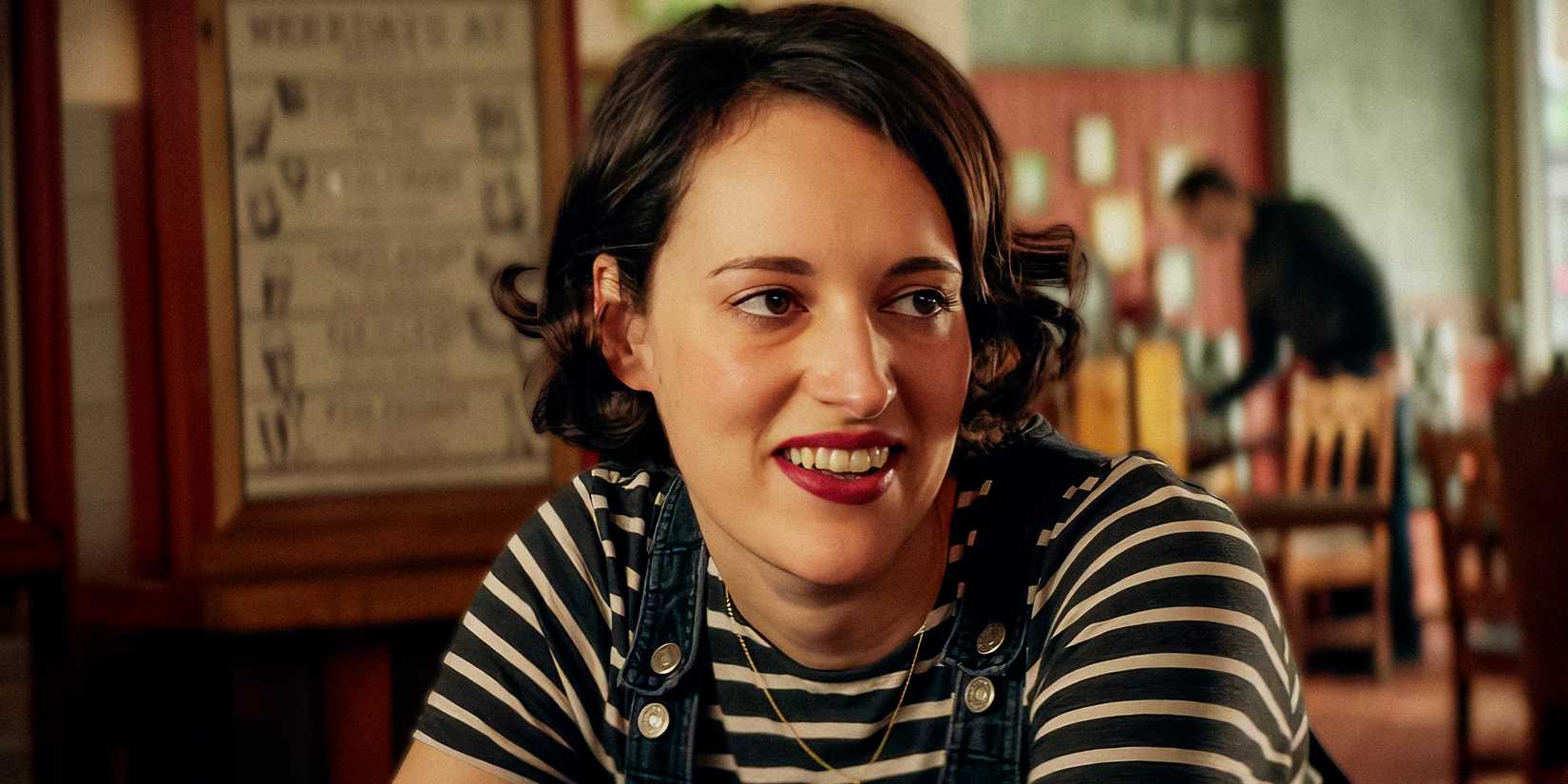 Fleabag (Phoebe Waller-Bridge) wearing a striped top and smirking in Fleabag