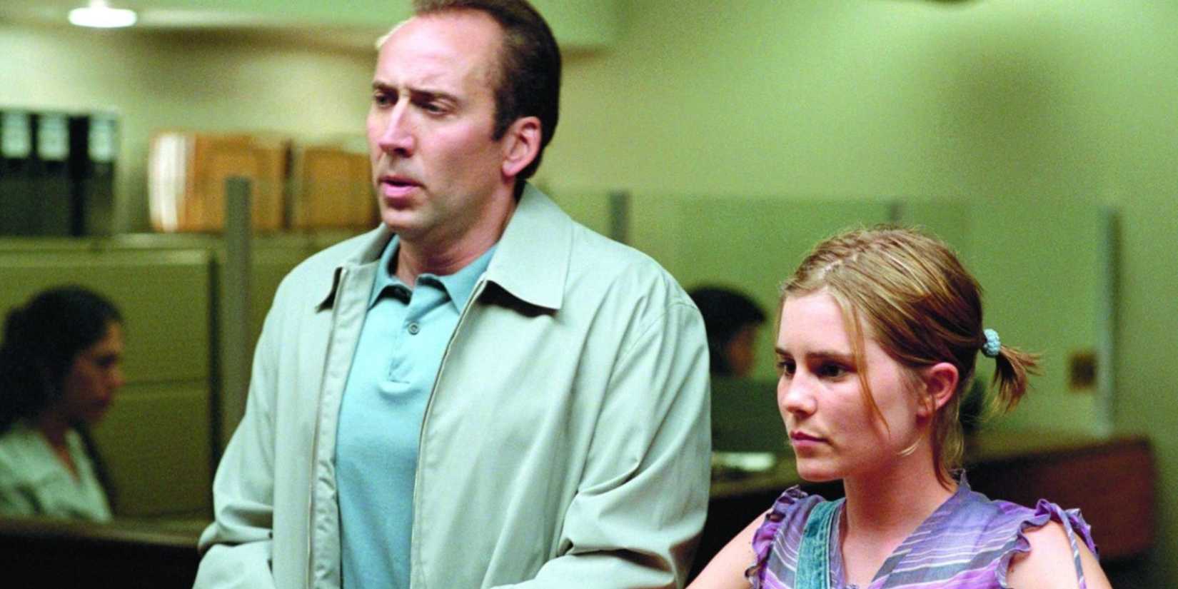 Nicolas Cage as Roy Waller standing with Alison Lohman as Angela in Matchstick Men