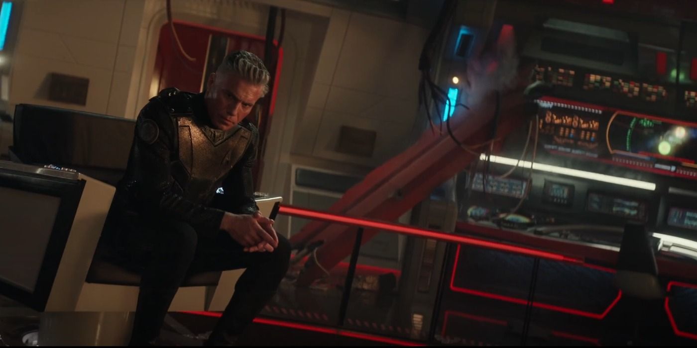 Pike sitting in the captains chair on the damaged Enterprise bridge in Star Trek Strange New Worlds Hegemony Part II
