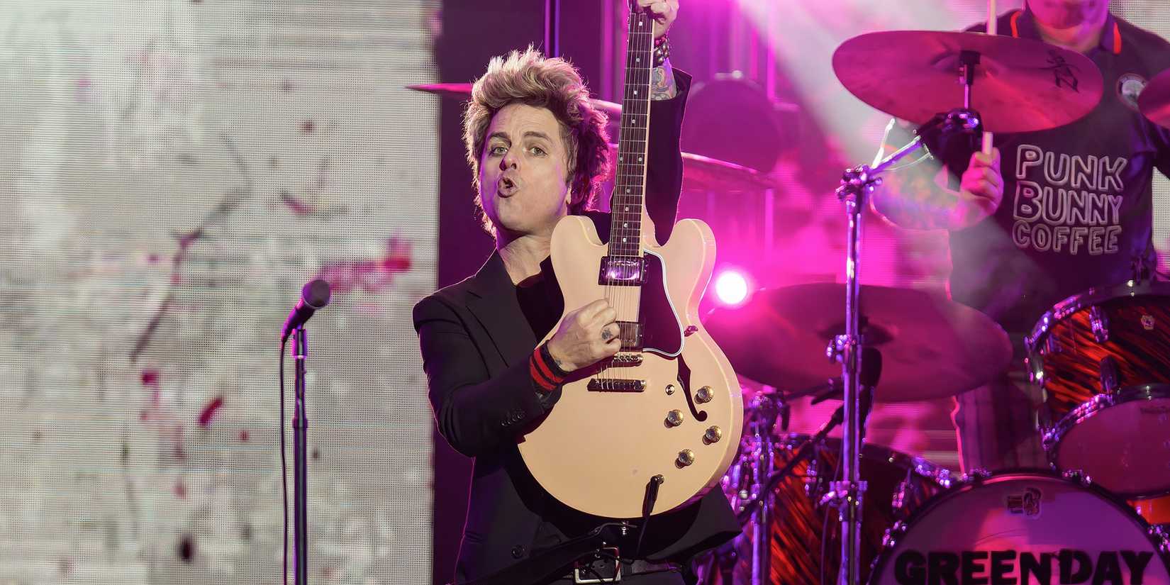 Billie Joe Armstrong of Green Days plays his guitar live during a performance.