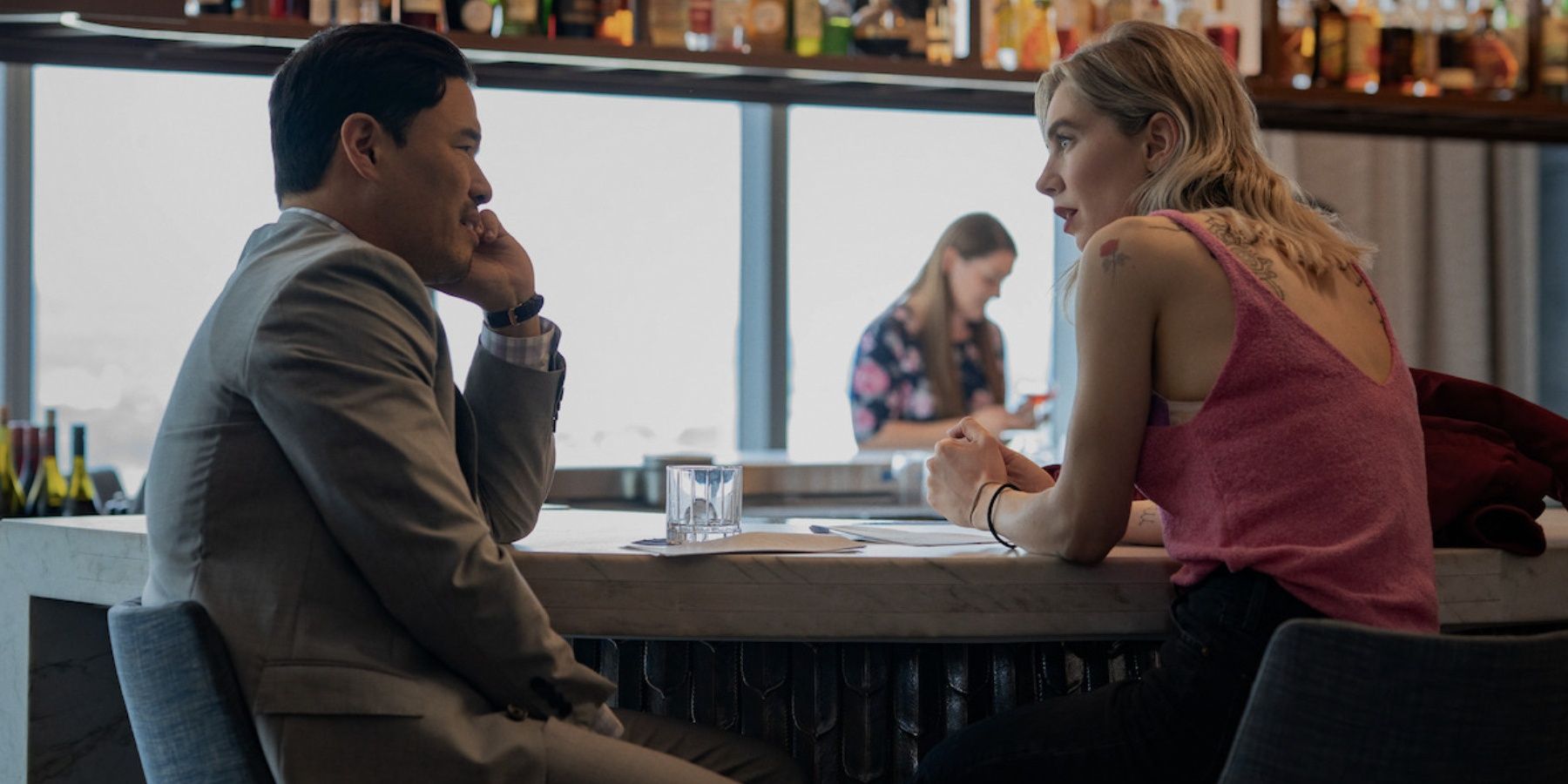 Randall Park and Vanessa Kirby speak at a bar in Night Always Comes