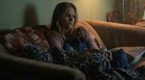 Jennifer Jason Leigh on a couch in Night Always Comes