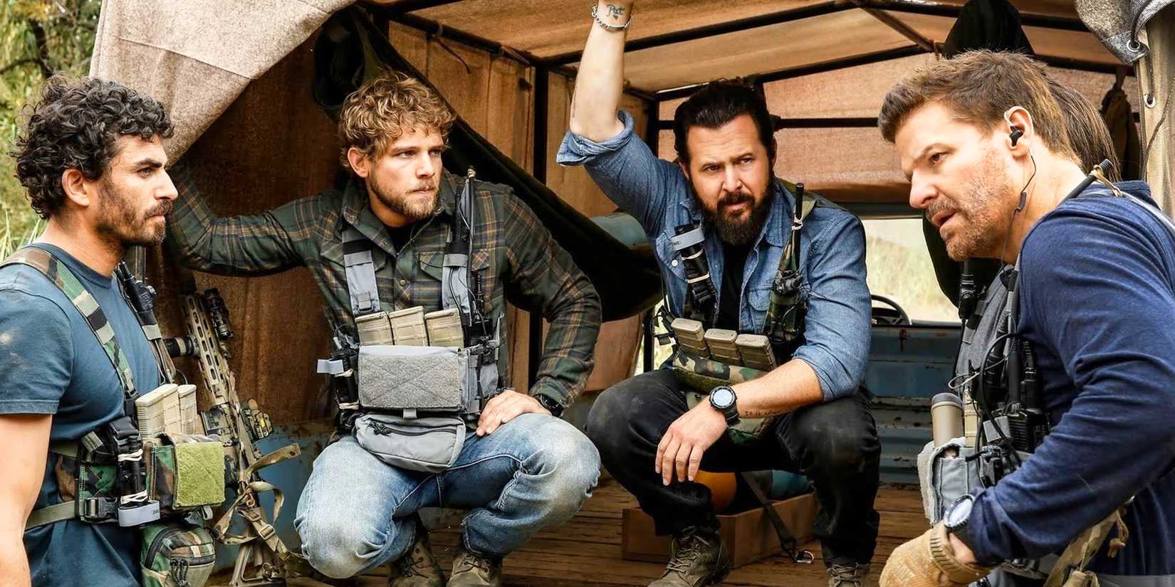 SEAL Team's cast sitting crouched and talking to each other in the back of a van