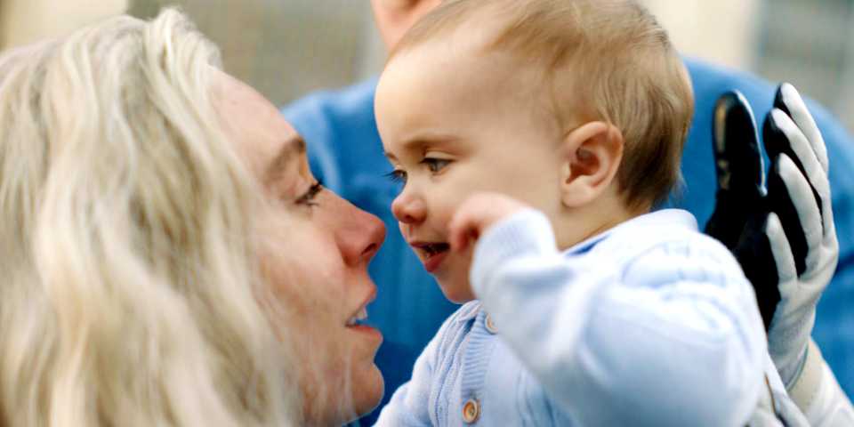 Sue Storm holds a baby Franklin Richards close to her face in The Fantastic Four: First Steps