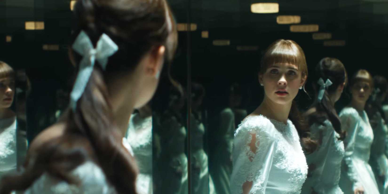 Mia Tomlinson as Judy looking terrified in a hall of mirrors in The Conjuring: Last Rites