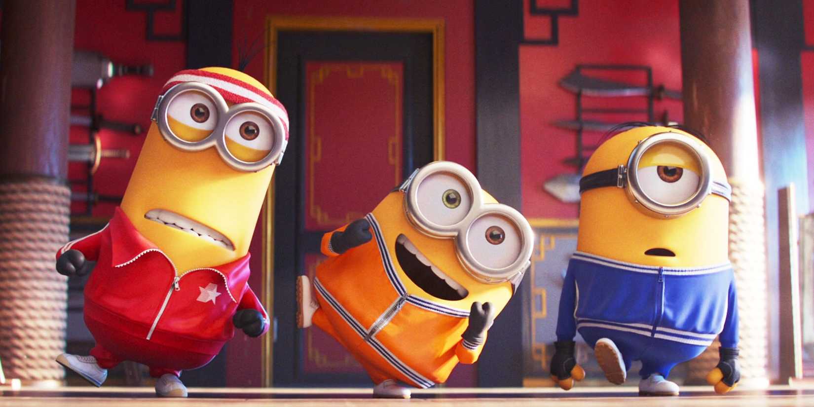 Three minions from Despicable Me wearing colorful suits
