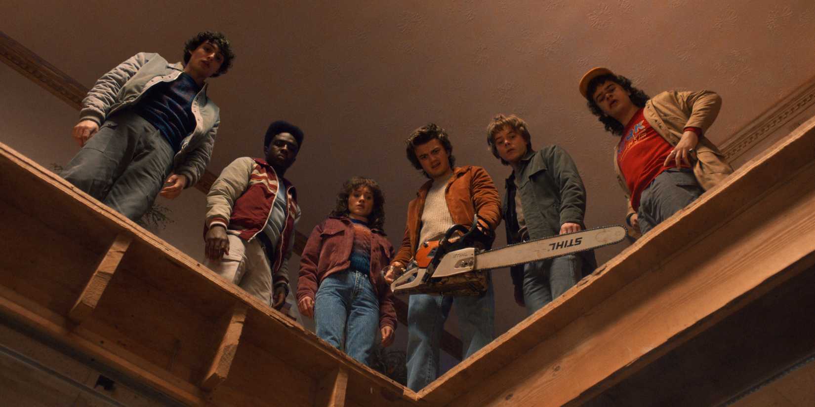 The Main Characters Looking Down At Something In Stranger Things Season 5