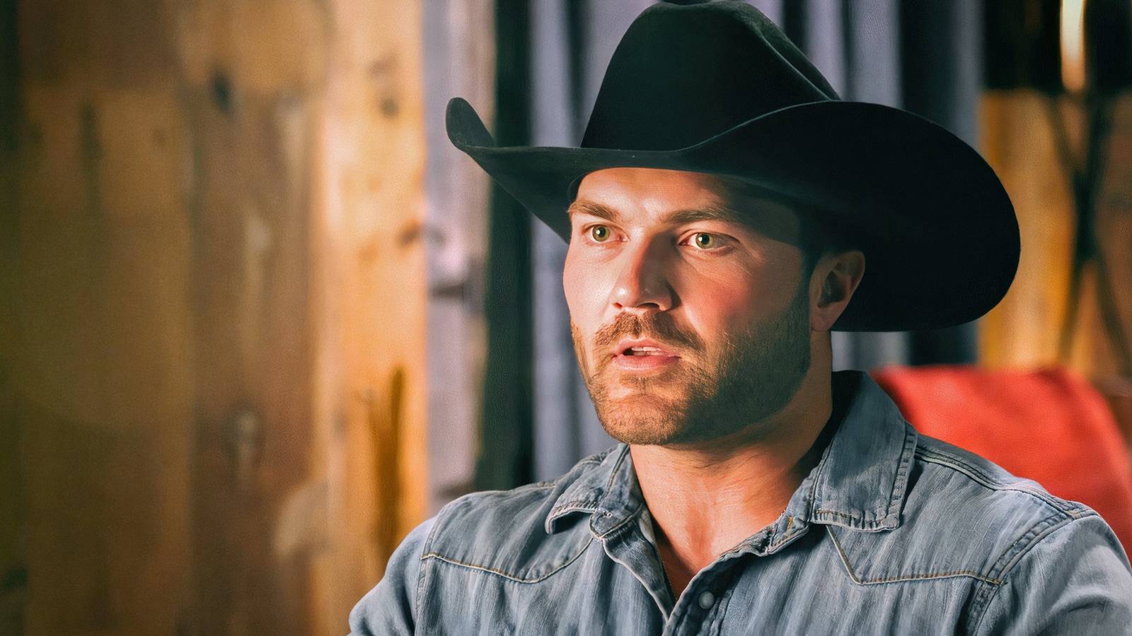 the mcbee dynasty star steven mcbee in a cowboy hat and denim shirt looking serious