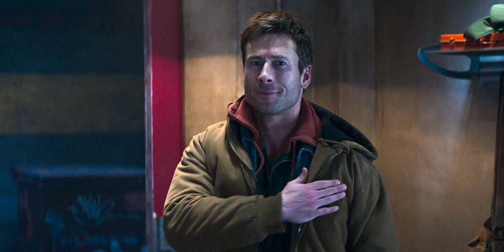 Ben Richards (Glen Powell) with his hand on his chest, as if making a promise in The Running Man (2025)