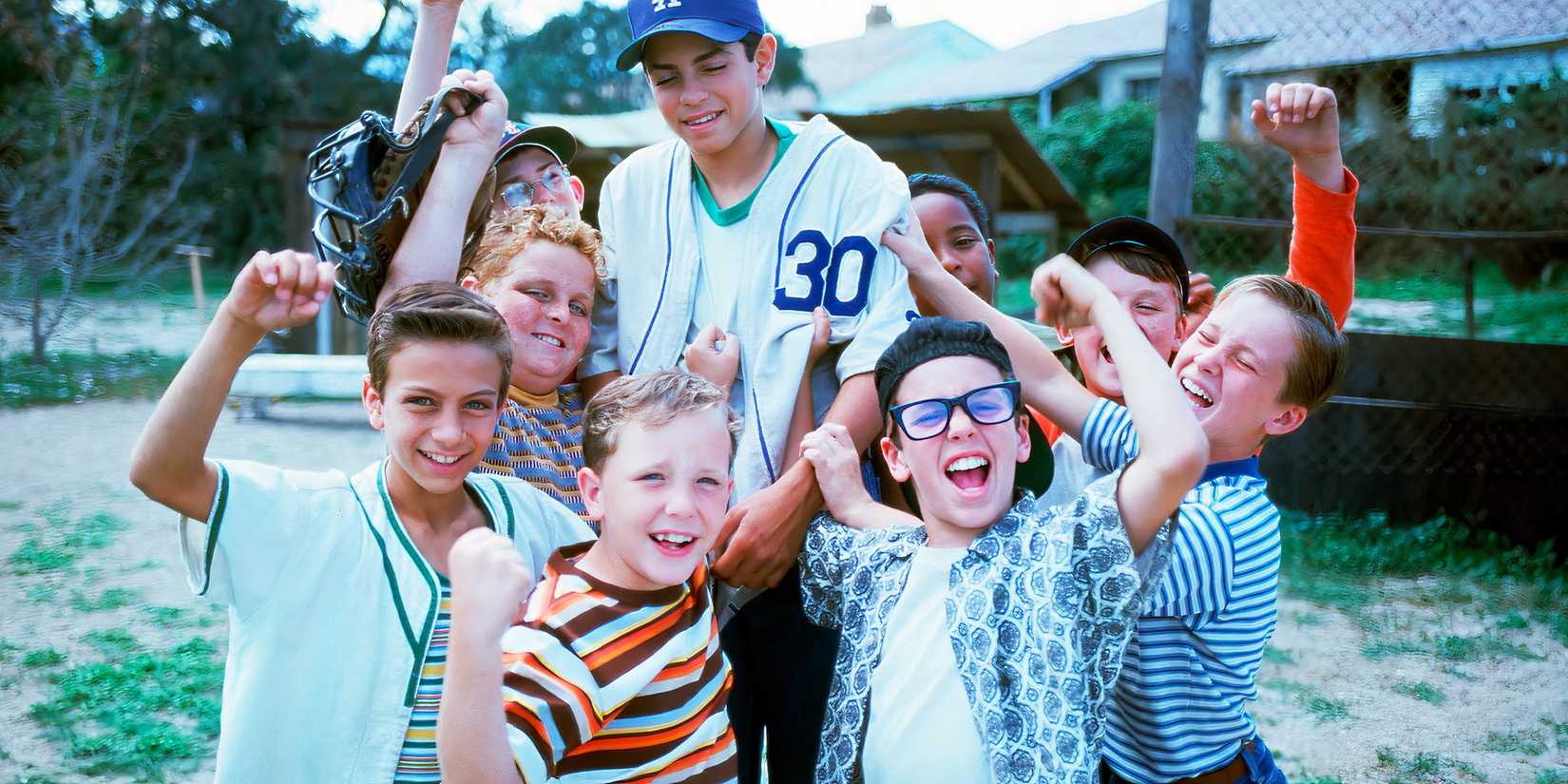 The group of boys holding up a team member and cheering in The Sandlot