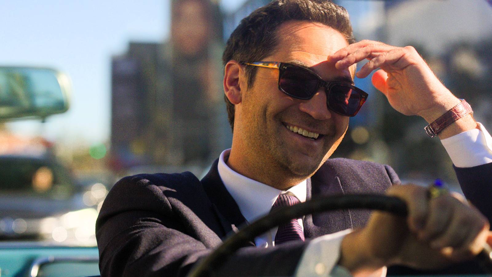 Mickey Haller smiles while driving the car in The Lincoln Lawyer