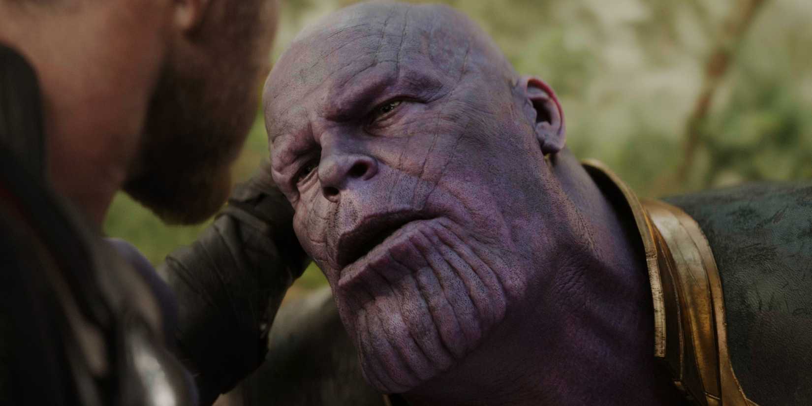 Thor holding Thanos' head as he stabs him in Avengers: Infinity War