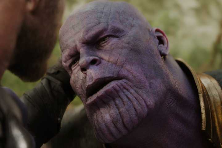 Thor holding Thanos' head as he stabs him in Avengers: Infinity War