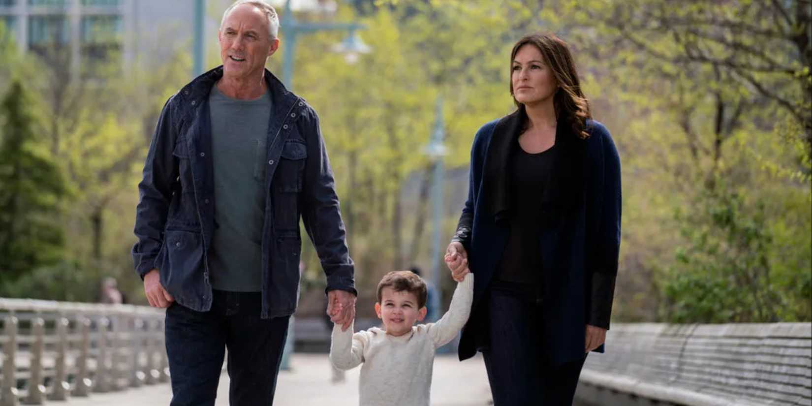 Tucker and Olivia holding hands with Noah in the park in Law and Order SVU