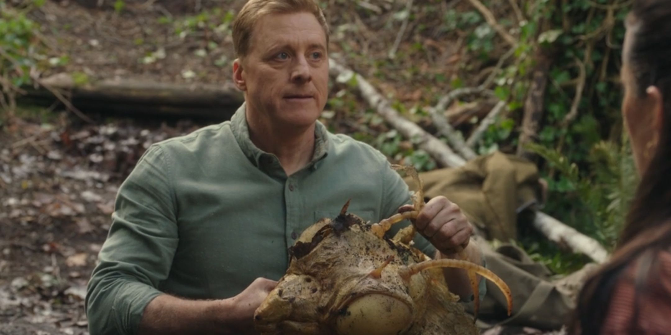 Alan Tudyk as Harry Vanderspeigle holding the Mantid's head in Resident Alien