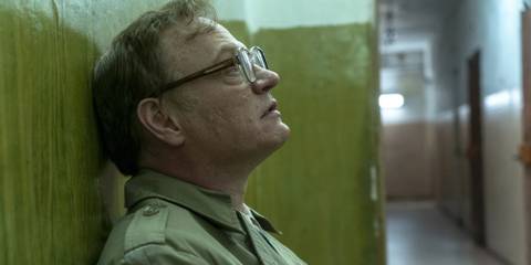 Valery (Jared Harris) leaning against a wall in shock in Chernobyl.