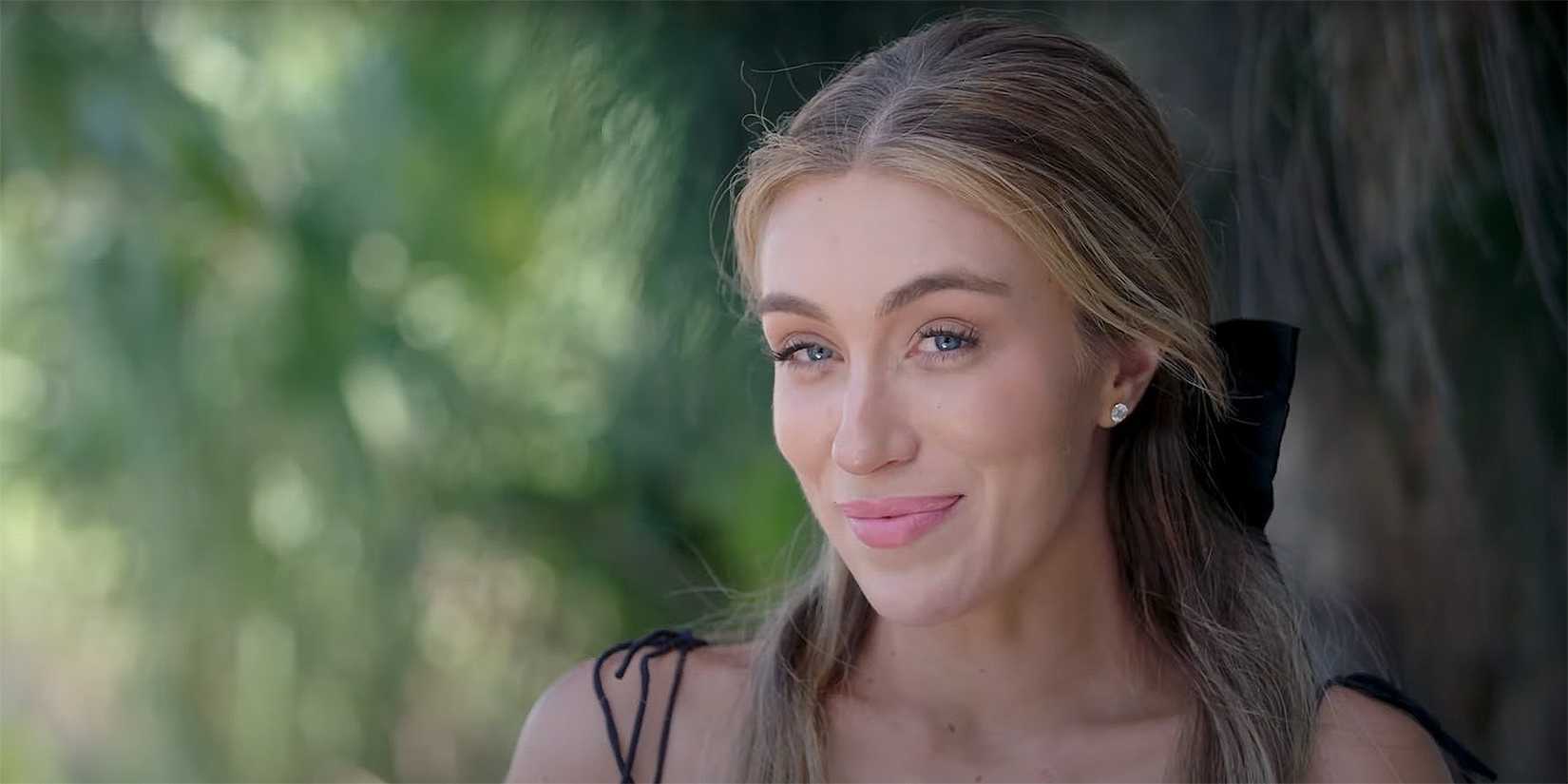 Veronica Peters from Welcome To Plathville smiling for the camera in a black dress.