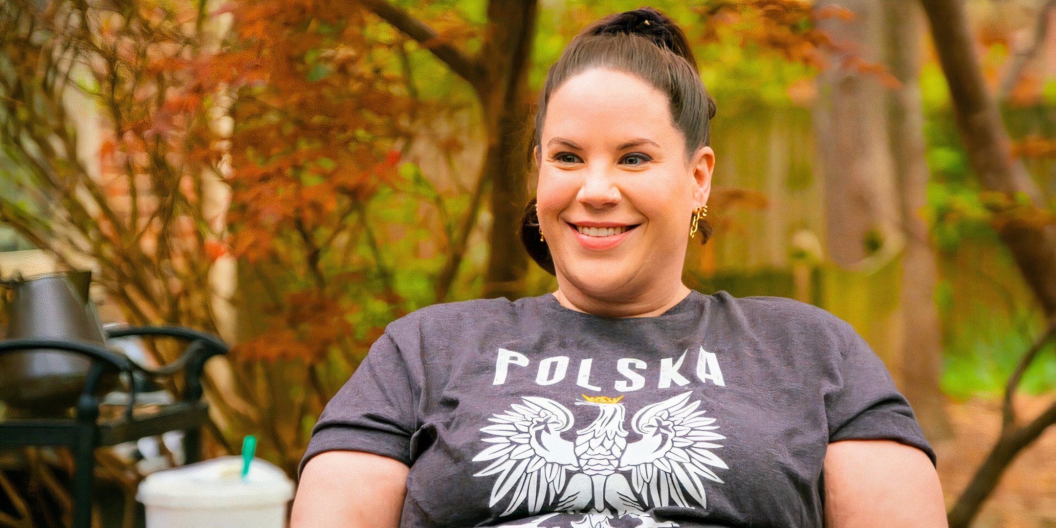 Whitney Thore from My Big Fat Fabulous Life smiilng in a gray t shirt outside