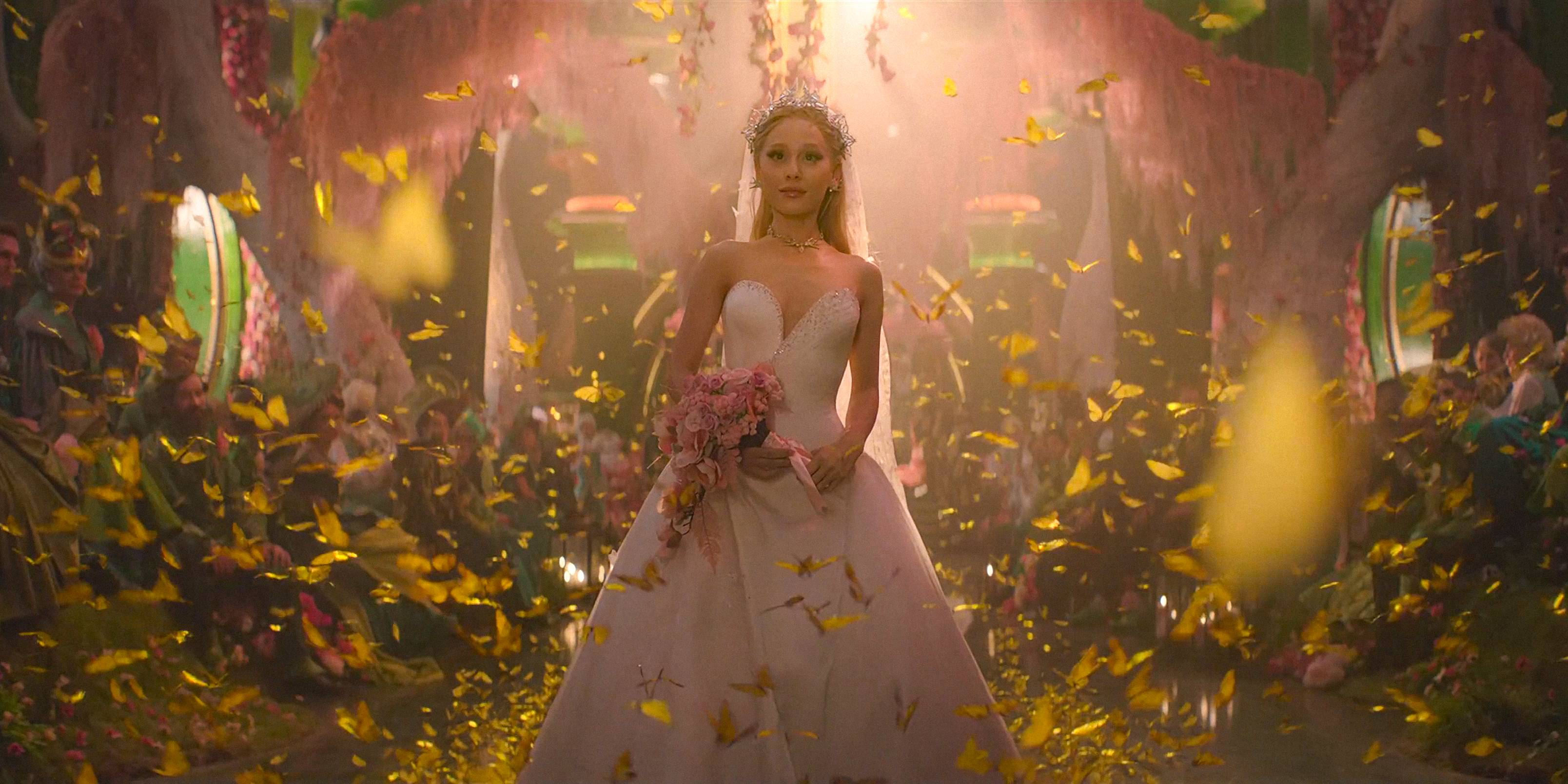 Glinda (Ariana Grande) walking down the aisle surrounded by yellow butterflies in Wicked: For Good
