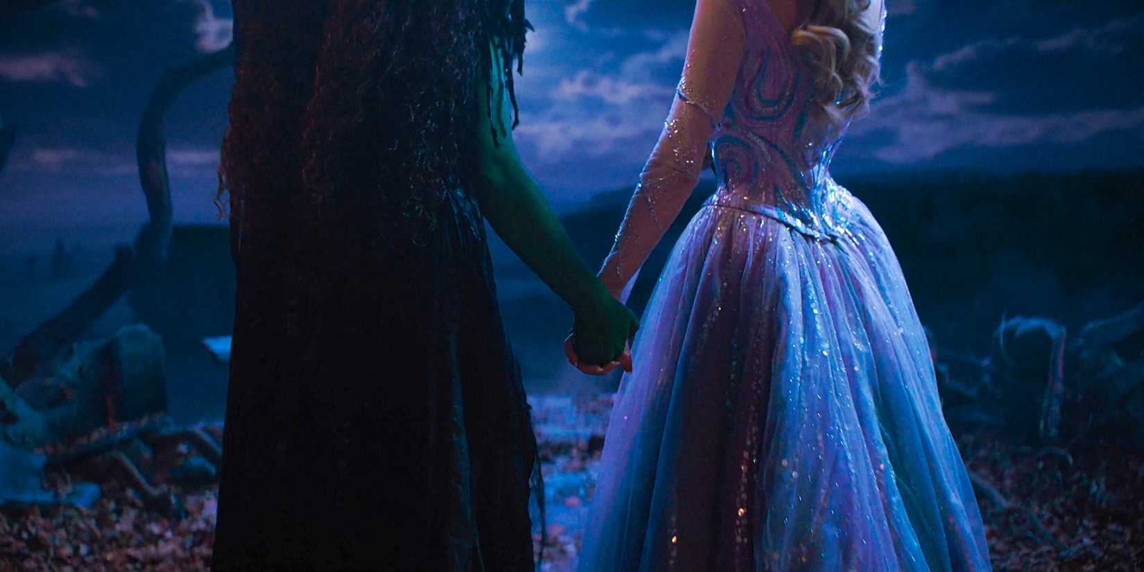 Elphaba (Cynthia Erivo) and Glinda (Ariana Grande) holding hands in Wicked: For Good
