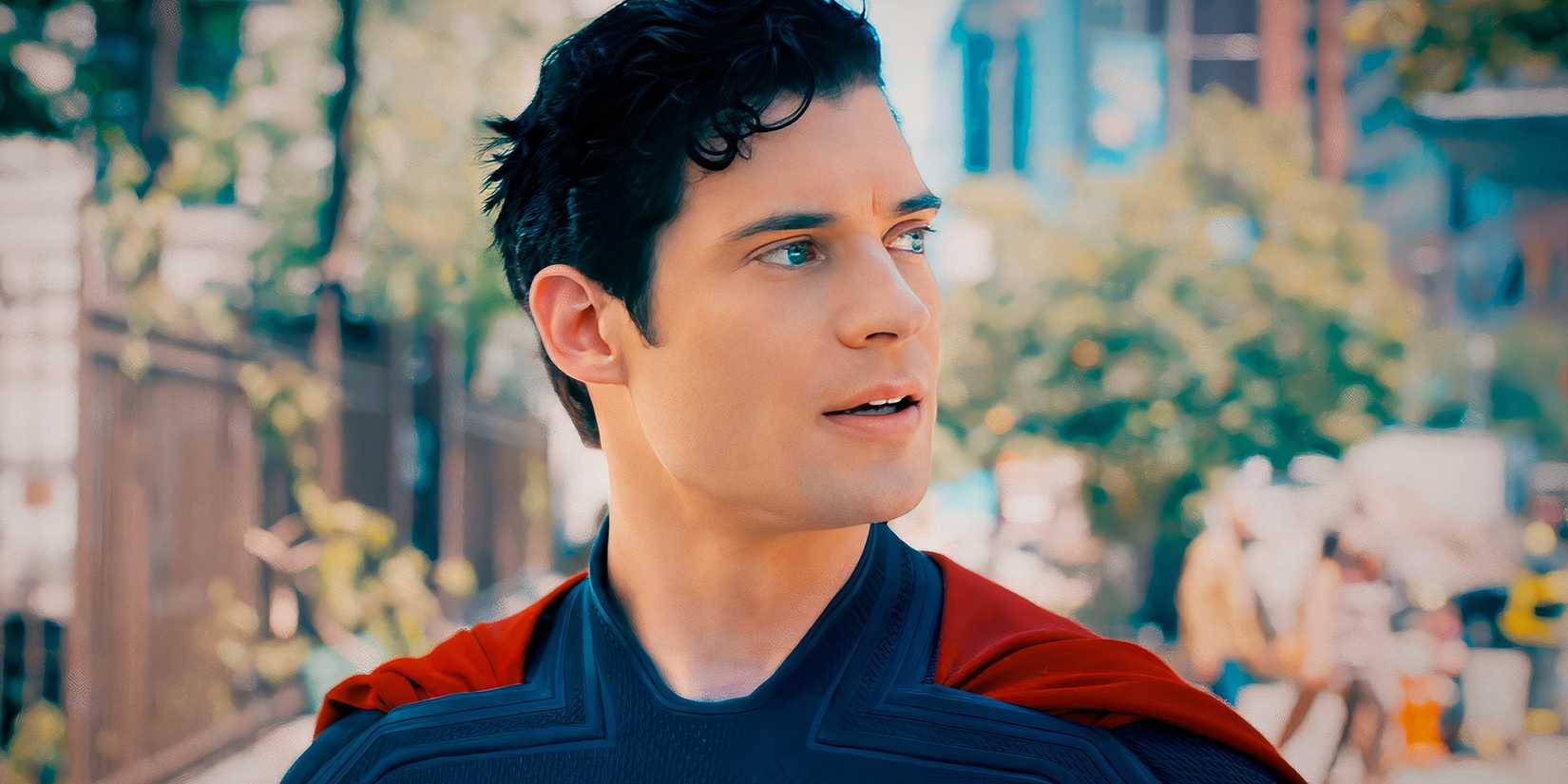 David Corenswet as Superman looking to the side on a sunny and leafy street in Superman 2025