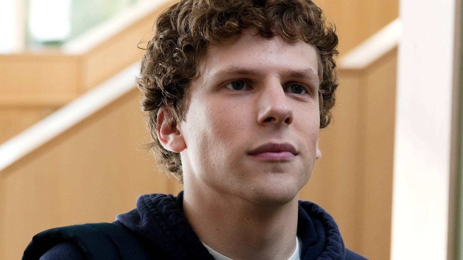 A close-up of Jesse Eisenberg looking smug in The Social Network