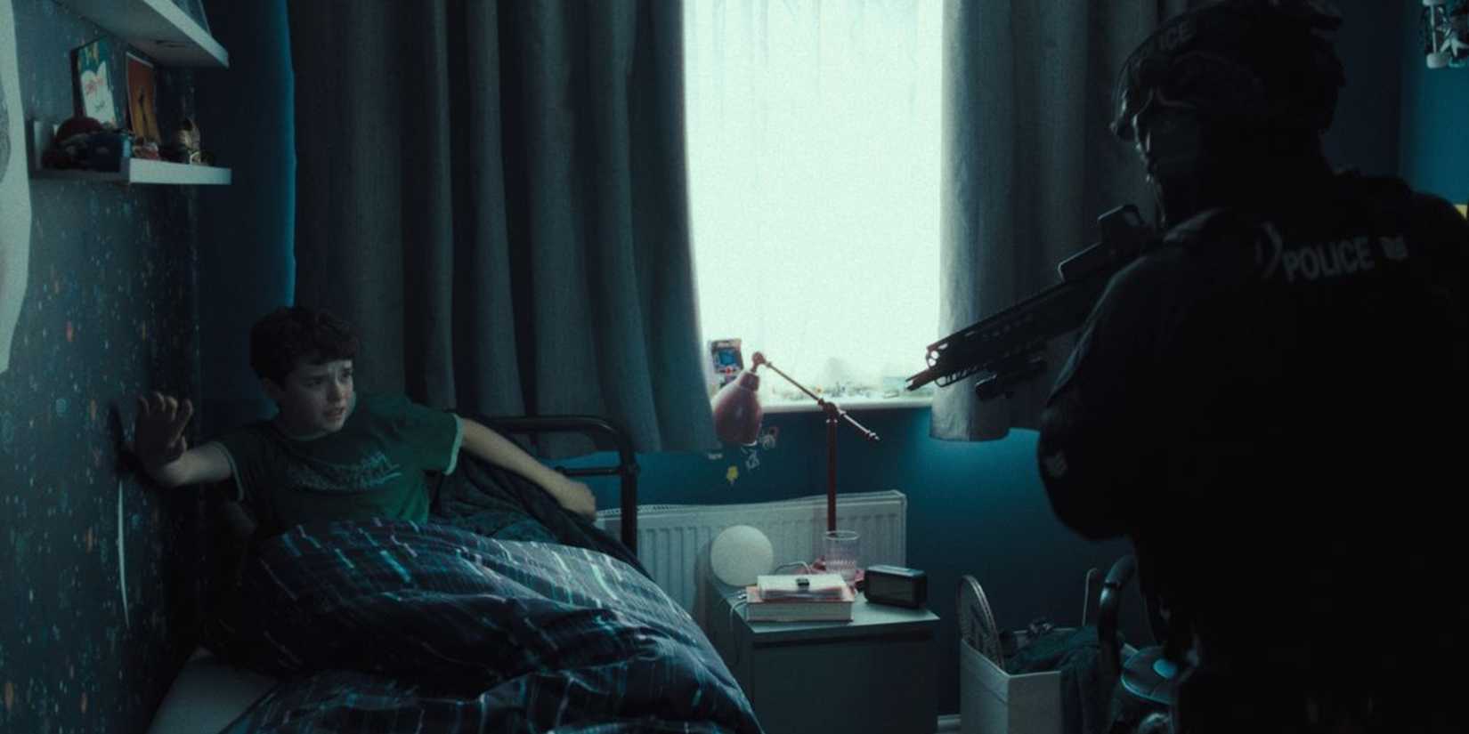 A police officer points a gun at Jamie in Adolescence