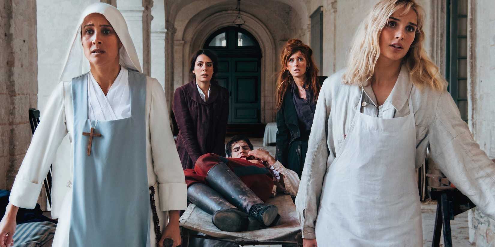 A soldier being carried on a stretcher in Women at War