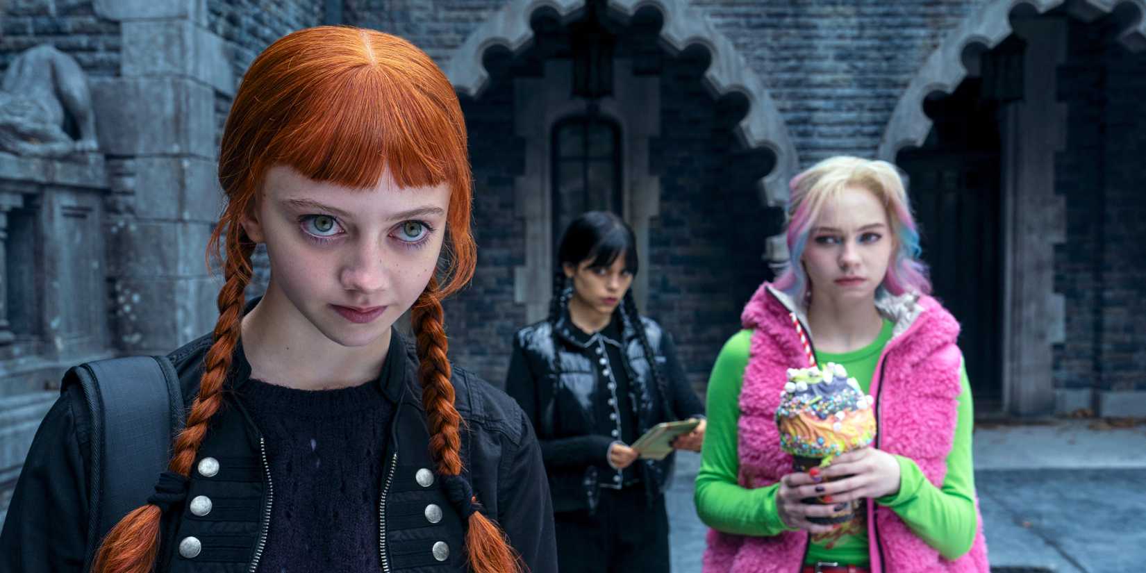 Agnes looking determined with Enid and Wednesday behind her in season 2