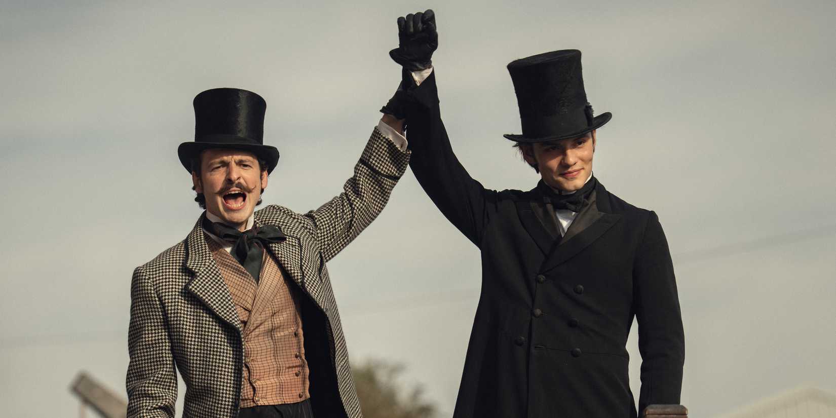 Anthony Boyle holding up Louis Partridge's arm from House of Guinness
