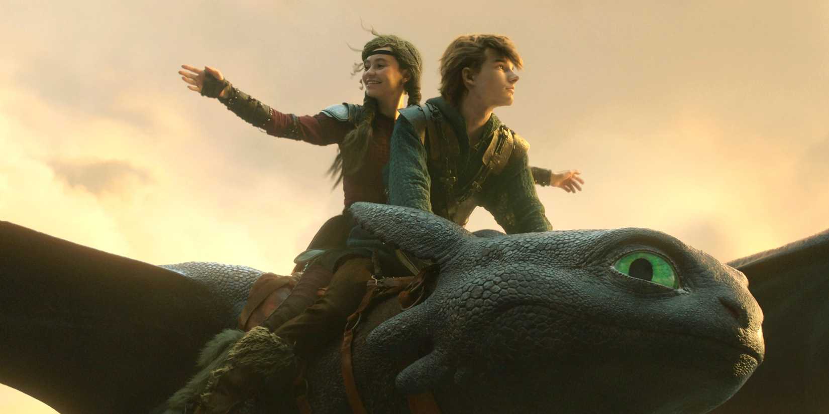 Astrid and Hiccup flying with Toothless through the sky in How to Train Your Dragon 2025