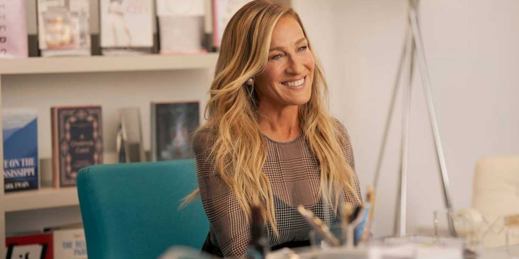 carrie bradshaw sarah jessica parker smiling in her editor s office in and just like that season 3 episode 11