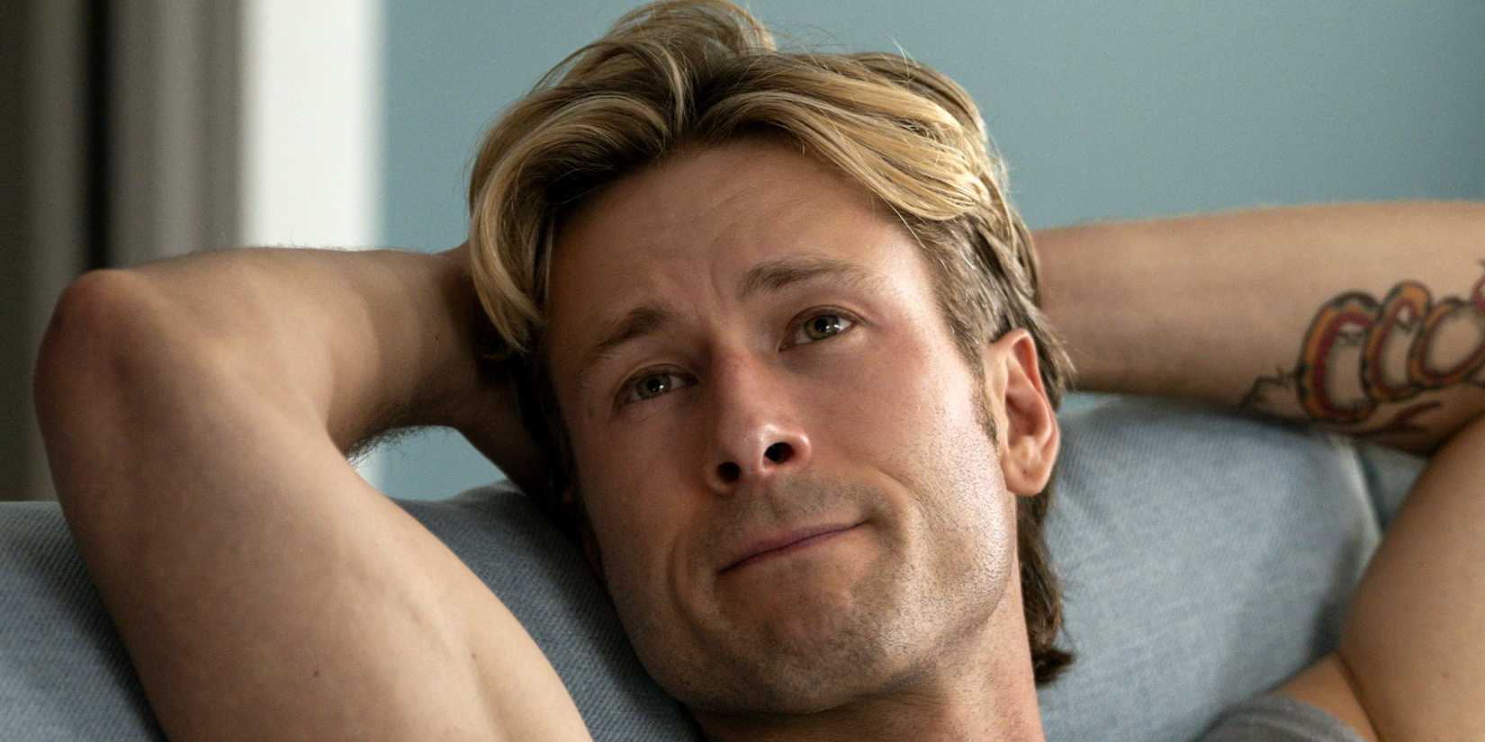 Russ (Glen Powell) relaxing with his arms back in Chad Powers