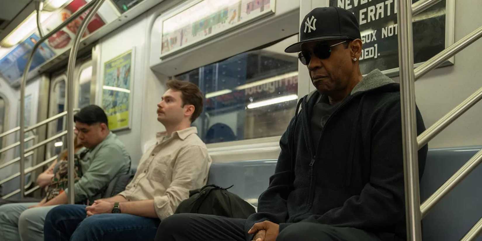 Denzel Washington sitting on the subway with sunglᴀsses and baseball hat in Highest 2 Lowest